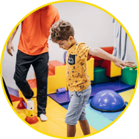 Student exercising with therapist in sensory room Student exercising with therapist in sensory room